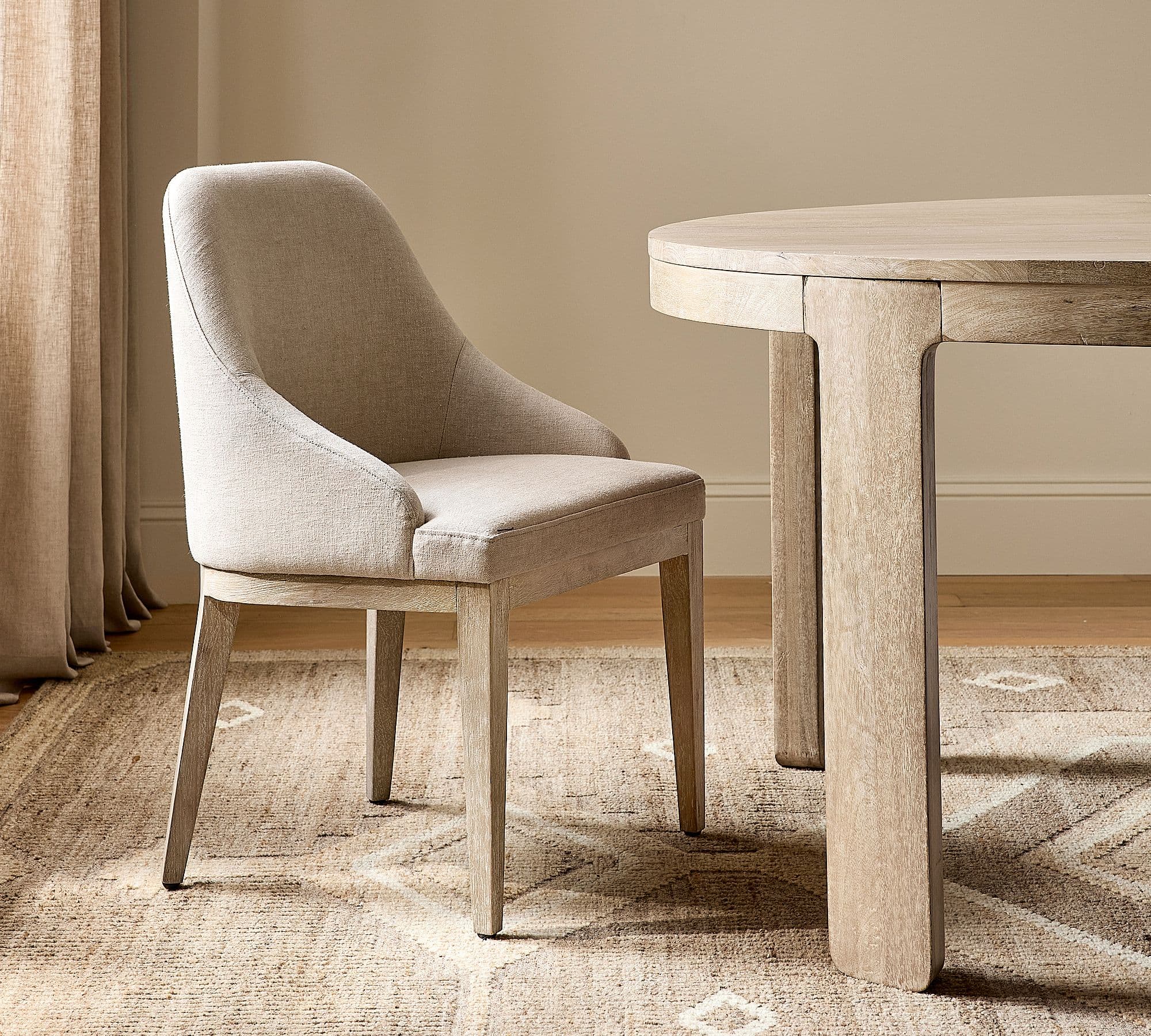 Pottery Barn Layton Upholstered Dining Armchair (each) styled in a dining room